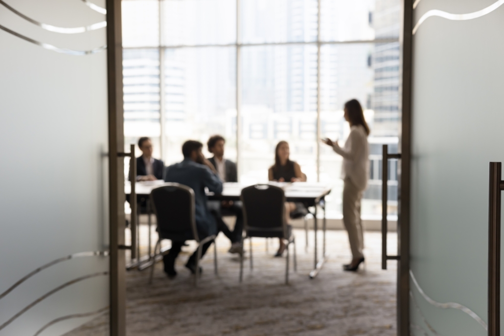 Silhouettes,Of,Businesspeople,Gathered,In,Conference,Room,For,Negotiation,Or